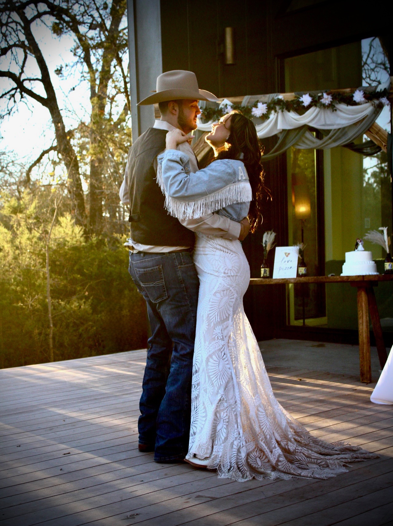 A couple's first dance on the deck at golden hour