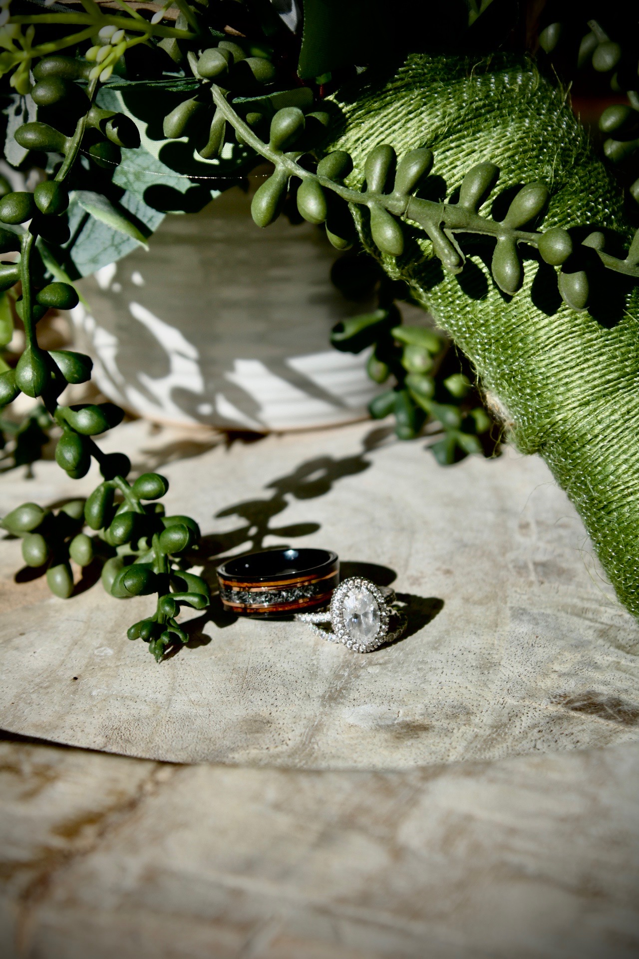 Wedding rings resting on greenery